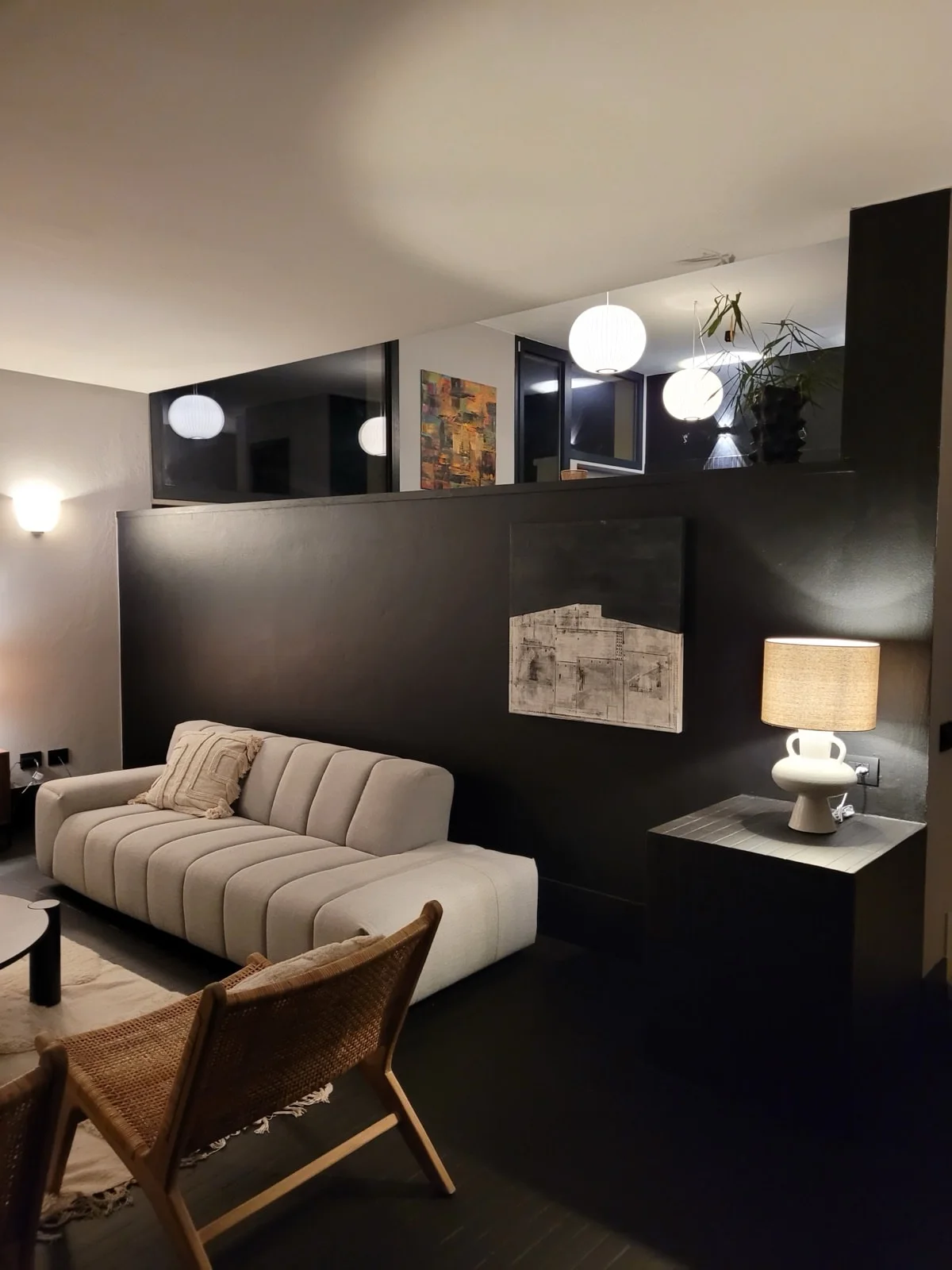 Living room with gallery level and pendant lights