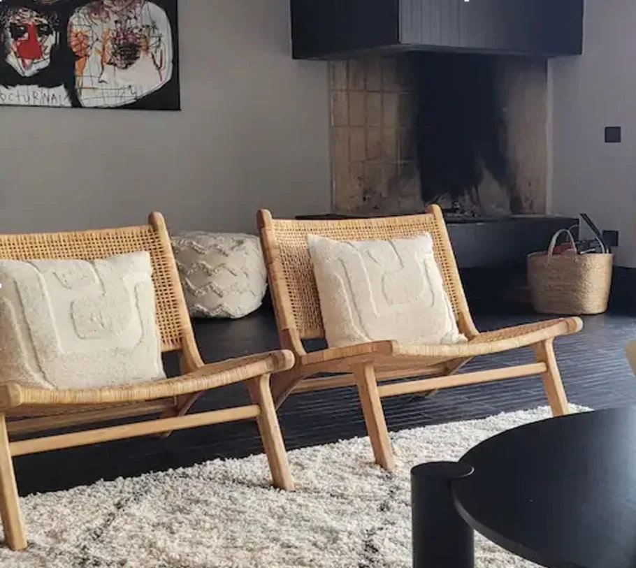 Rattan lounge chair in front of the fireplace